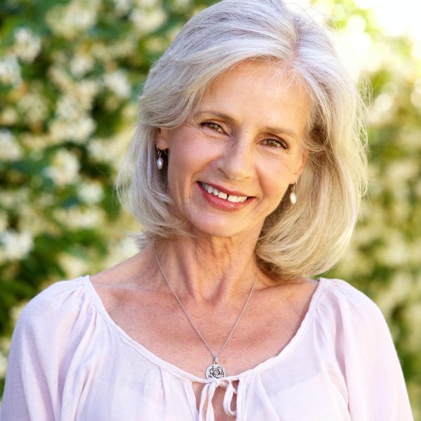 happy-older-woman-standing-in-garden.jpg